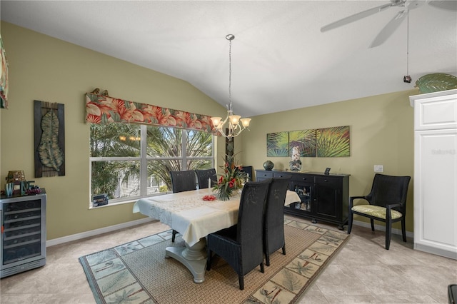 dining area featuring ceiling fan with notable chandelier, lofted ceiling, and beverage cooler