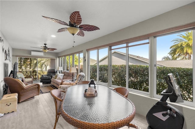 sunroom / solarium featuring ceiling fan and a wall unit AC