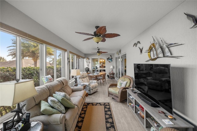 living room featuring ceiling fan and light wood-type flooring