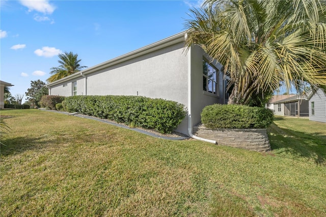 view of property exterior with a yard