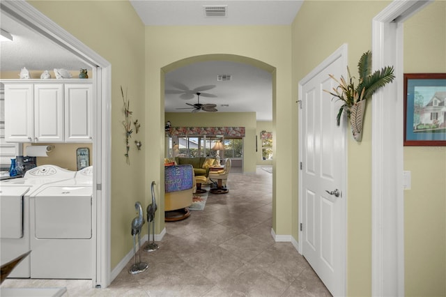 clothes washing area with cabinets, washer and clothes dryer, and ceiling fan