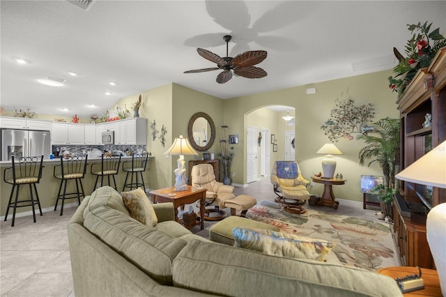 living room featuring ceiling fan and light tile patterned floors