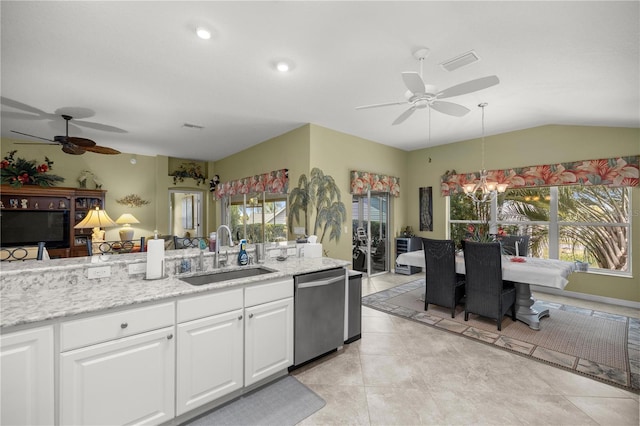 kitchen featuring sink, light tile patterned floors, decorative light fixtures, dishwasher, and white cabinetry