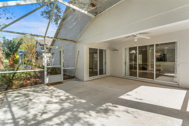 unfurnished sunroom with lofted ceiling and ceiling fan