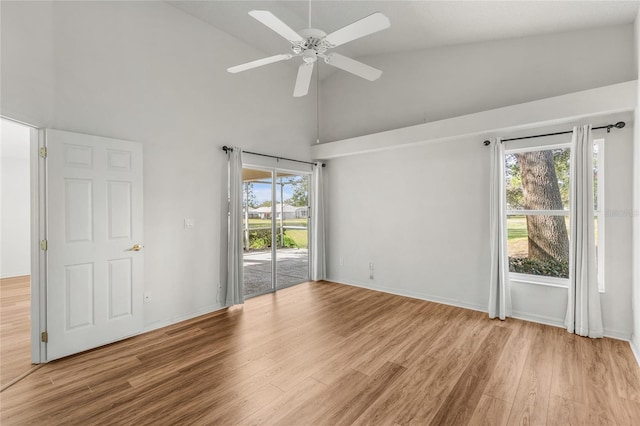 spare room with ceiling fan, light hardwood / wood-style floors, and a wealth of natural light