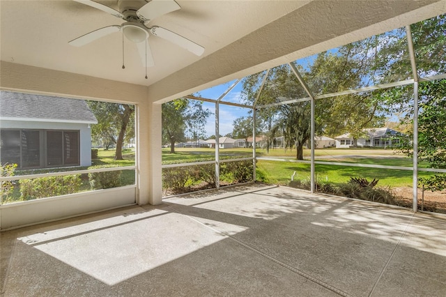 unfurnished sunroom featuring ceiling fan