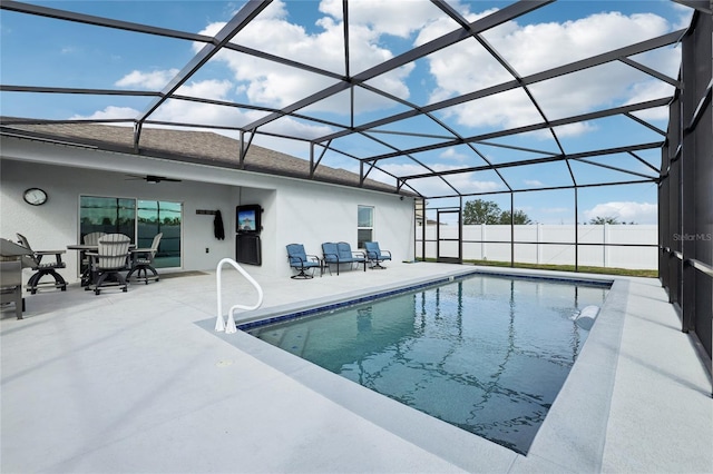 view of pool with a patio, ceiling fan, and a lanai