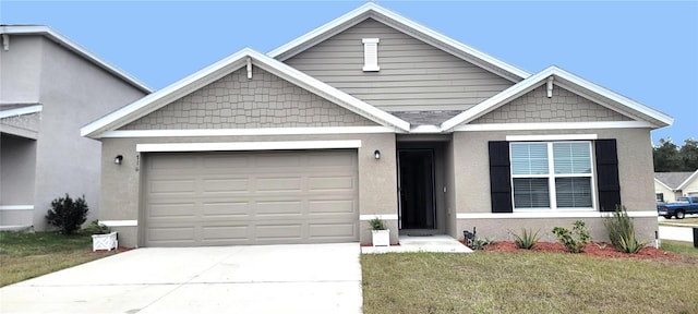 view of front facade featuring a garage and a front lawn