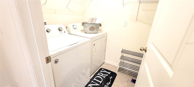 laundry area featuring separate washer and dryer and light tile patterned flooring