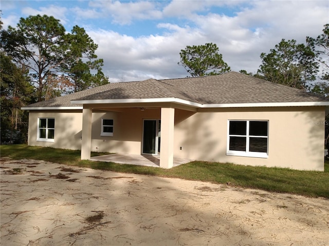 rear view of house featuring ceiling fan and a patio area