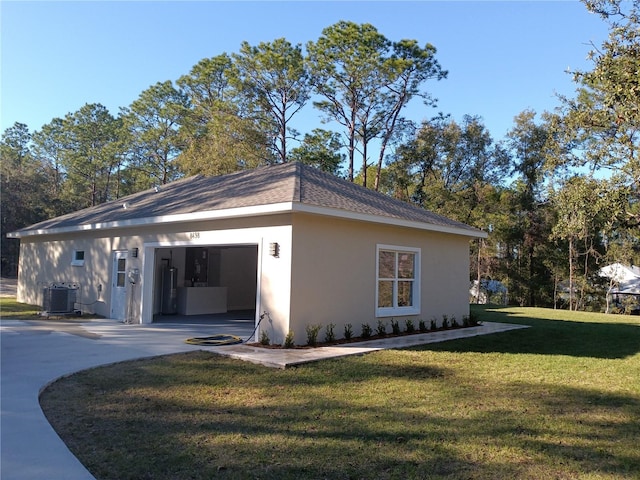 view of home's exterior with a garage, a lawn, and central AC