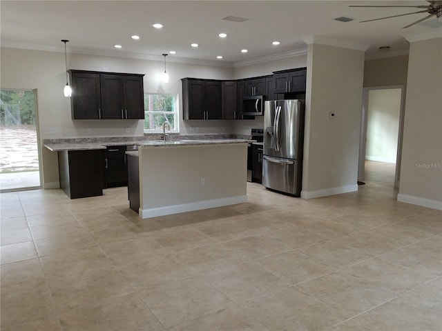 kitchen featuring decorative light fixtures, ceiling fan, a center island, sink, and appliances with stainless steel finishes