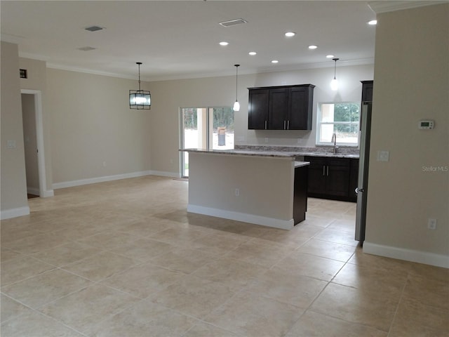 kitchen featuring stainless steel refrigerator, crown molding, hanging light fixtures, light stone countertops, and light tile patterned floors