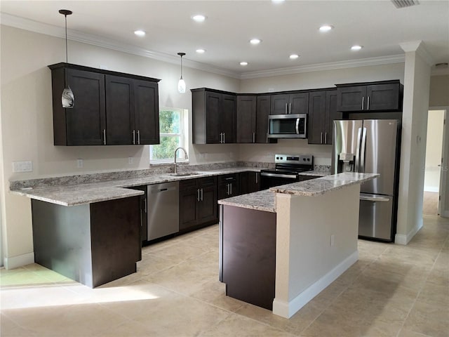 kitchen with light stone countertops, a kitchen island, decorative light fixtures, stainless steel appliances, and sink