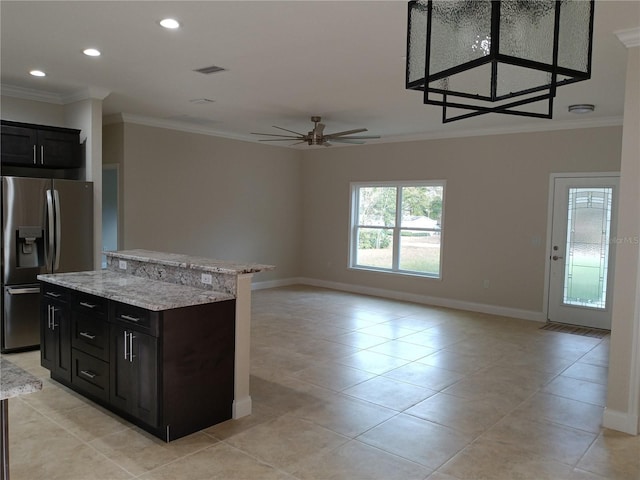 kitchen with ceiling fan, stainless steel refrigerator with ice dispenser, ornamental molding, and a kitchen island