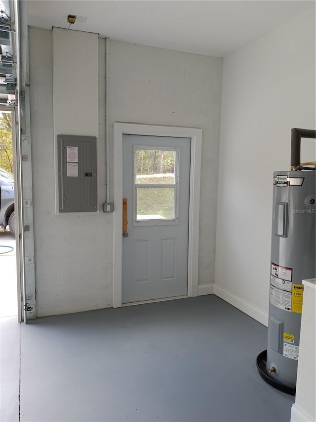 doorway to outside with electric panel, electric water heater, and concrete floors