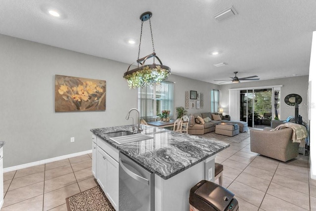 kitchen with sink, pendant lighting, dishwasher, white cabinetry, and an island with sink