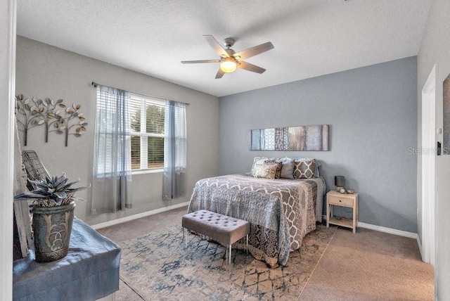 carpeted bedroom with a textured ceiling and ceiling fan