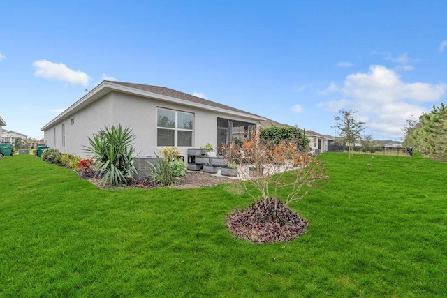 rear view of property featuring a yard