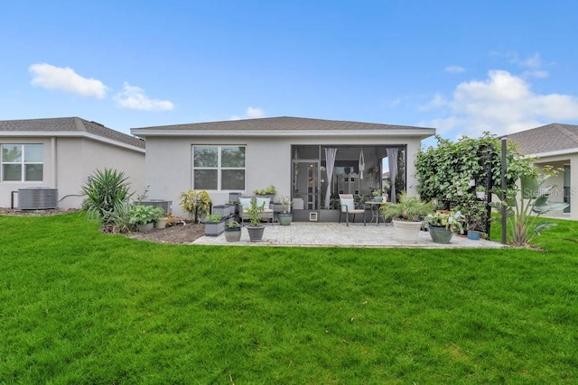 back of property with central air condition unit and a yard