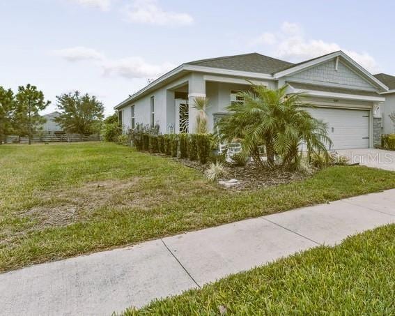 view of front facade featuring a garage and a front lawn