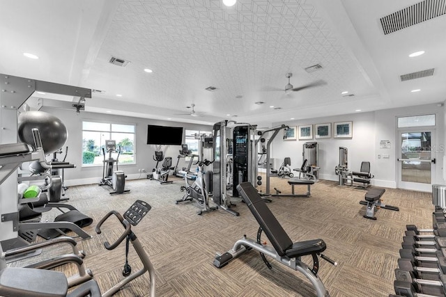 workout area featuring light colored carpet and ceiling fan