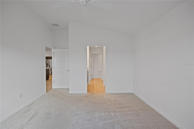 carpeted spare room with ceiling fan and high vaulted ceiling