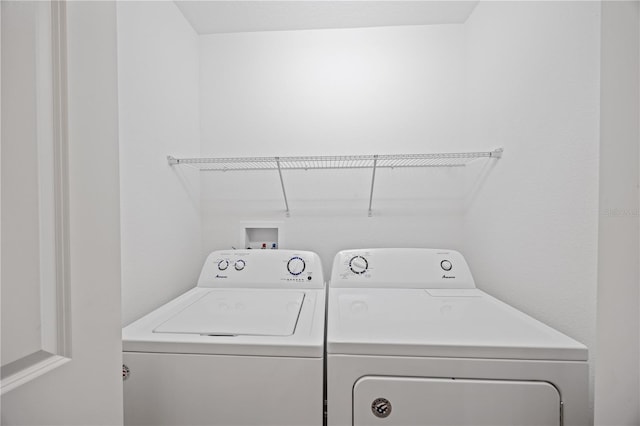 clothes washing area with washing machine and clothes dryer