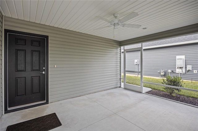 unfurnished sunroom with ceiling fan