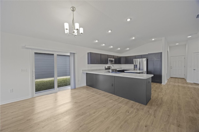 kitchen featuring pendant lighting, vaulted ceiling, kitchen peninsula, stainless steel appliances, and a chandelier