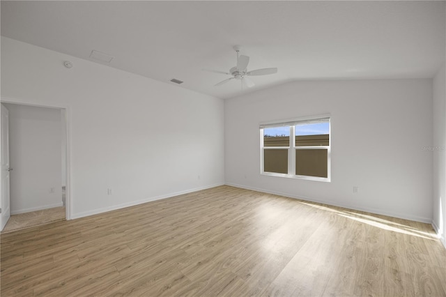 spare room featuring vaulted ceiling, light hardwood / wood-style flooring, and ceiling fan