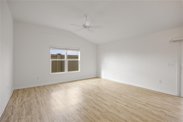 empty room with ceiling fan, light wood-type flooring, and vaulted ceiling