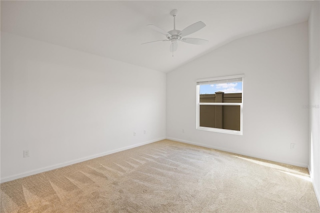 carpeted empty room featuring ceiling fan and lofted ceiling