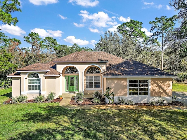 mediterranean / spanish-style home featuring a front lawn