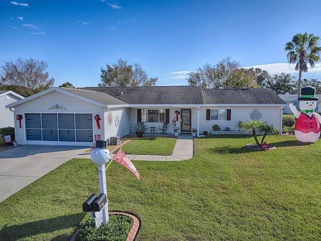 ranch-style home featuring a front lawn and a garage