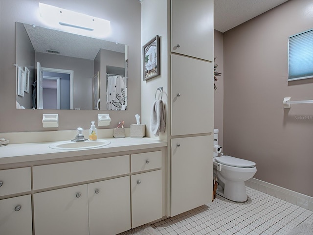 bathroom with vanity, toilet, and tile patterned flooring