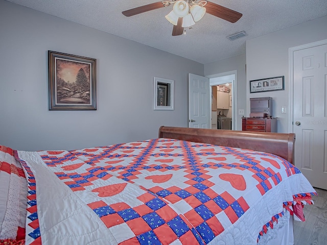 bedroom with hardwood / wood-style flooring, ceiling fan, and a textured ceiling