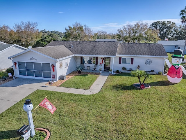 single story home with a garage and a front lawn