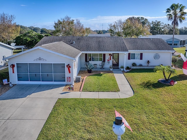 ranch-style house with a garage and a front lawn