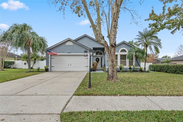 ranch-style home featuring a front lawn and a garage