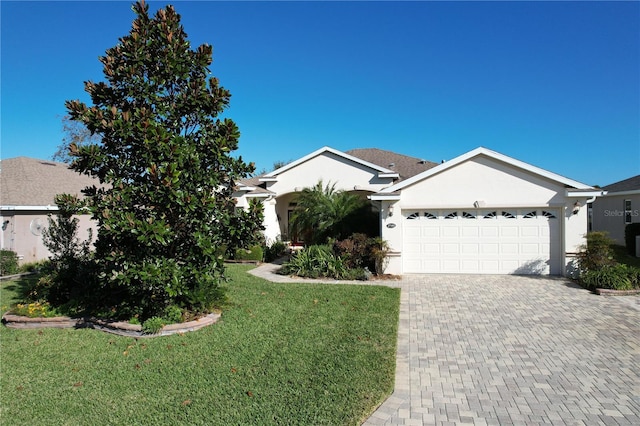 ranch-style house with a garage and a front lawn