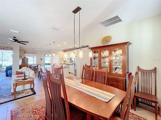 tiled dining room featuring ceiling fan