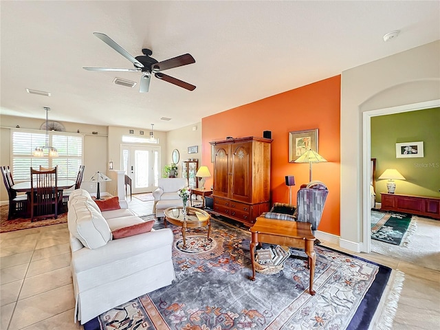 tiled living room featuring ceiling fan