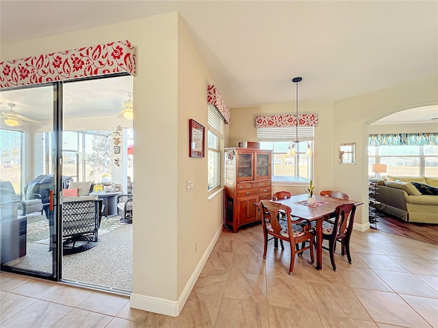 dining space with ceiling fan and light tile patterned floors