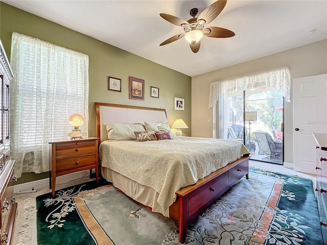 carpeted bedroom with ceiling fan and access to outside