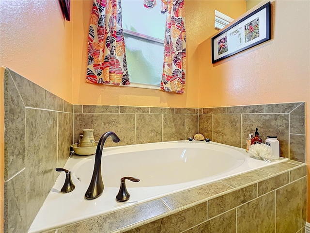 bathroom with a relaxing tiled tub