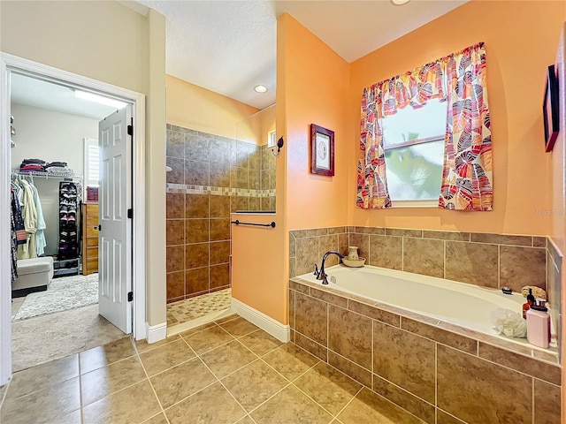 bathroom with tile patterned flooring and independent shower and bath