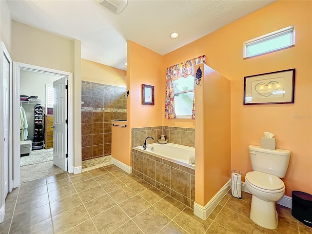 bathroom featuring tile patterned floors, separate shower and tub, and toilet