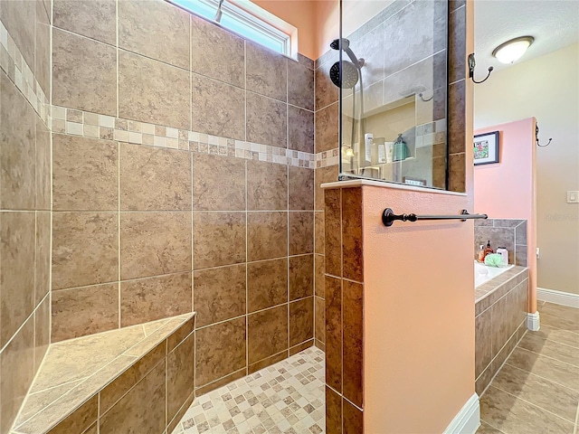 bathroom with tile patterned flooring and tiled shower