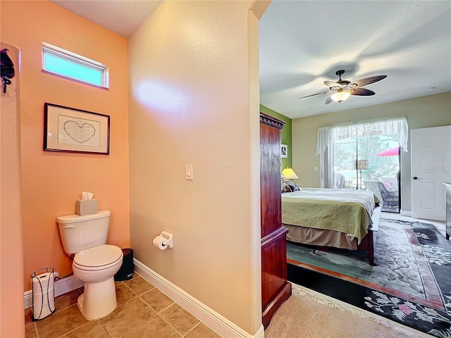 interior space featuring a wealth of natural light, ceiling fan, tile patterned flooring, and toilet